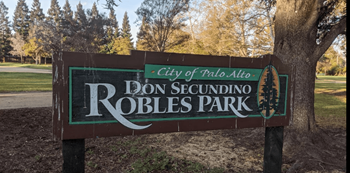 a sign in front of a tree